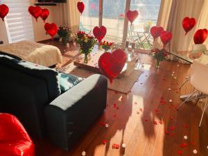 a living room with red hearts on the floor at Superbe Appartement avec vue sur le Lac du Bourget in Tresserves