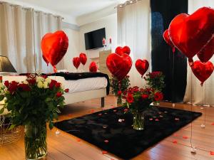 a living room with red heart balloons and flowers at Superbe Appartement avec vue sur le Lac du Bourget in Tresserves