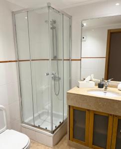 a bathroom with a shower and a toilet and a sink at Sesimbra Natural Room and private access in Sesimbra
