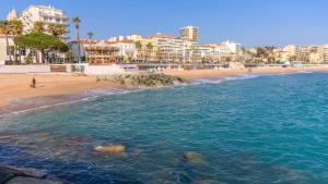 a view of a beach with buildings and the ocean at Hôtel de Flore in Saint-Raphaël