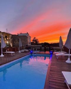 a swimming pool with a sunset in the background at ANTICA TENUTA CELOTTO in Vico Equense