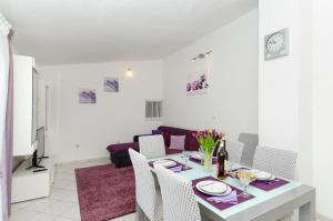 a white living room with a table and chairs at Apartment Zvonimir in Nečujam +24 photos