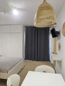a bedroom with a bed and a table and chairs at Apartamento Minerva Jupiter. The perfect accommodation for your vacation in Benalmádena