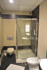 a bathroom with a shower and a toilet and a sink at Hotel Lukavac in Lukavac +16 photos