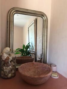 a bathroom with a large oval sink in front of a mirror at Derrière l'église in Saint Paul de Vence