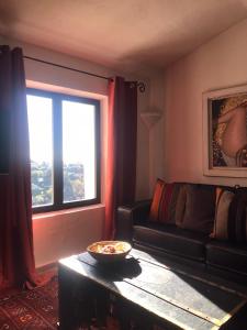 a living room with a couch and a window at Derrière l'église in Saint-Paul-de-Vence