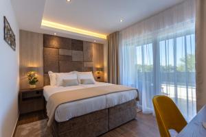 a bedroom with a large bed and a large window at Villa Fortis B&B in Trogir +36 photos