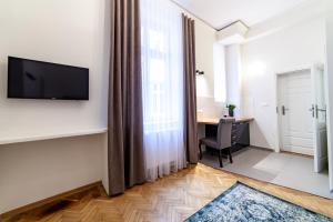 Televízia a/alebo spoločenská miestnosť v ubytovaní MILU Apartments Kurkowa