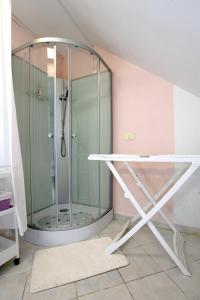a shower in a bathroom with a glass shower stall at City Studio Room with Bathroom DATE in Koper