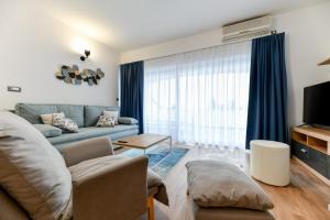 a living room with a couch and a tv at White Hill Apartment in Zadar