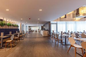 a dining room with tables and chairs and a cafeteria at Holiday Resort Ad Turres in Crikvenica