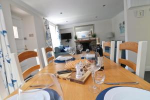 a dining room table with wine glasses on it at Idyllic Cottage near Padstow in Little Petherick