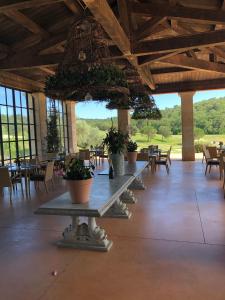 a row of tables with potted plants in a building at Charmantes Haus im Golf Club Saint Tropez in Saint-Tropez