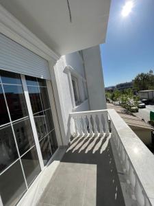 a balcony of a house with a stair railing at WHITE CROWN HOTEL in Kamëz