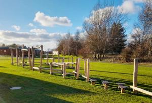 a row of wooden benches in a field at Boston West Hotel in Boston