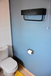a bathroom with a white toilet and a blue wall at Captivating 3-Bed house in Swansea Town center in Swansea