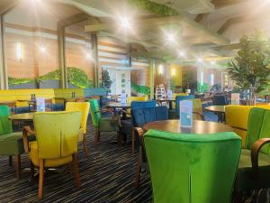 a dining room with colorful chairs and tables at Boston West Hotel in Boston