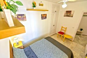 a small room with a bed and a chair at Plaza de Cárcel 3-bedroom Apartment in El Puerto de Santa María