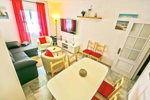 a living room with a couch and a table and chairs at Plaza de Cárcel 3-bedroom Apartment in El Puerto de Santa María