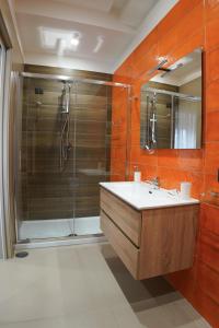 a bathroom with a shower and a sink and a mirror at Villa Mafalda B&B in Frattamaggiore