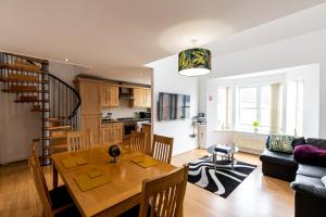 a kitchen and living room with a table and a dining room at A Jungle in Houston, Warrington, Great Sankey in Great Sankey