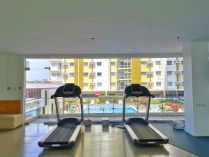 a gym with a swimming pool in a building at Pool View Studio in Mesaverte with Free Pool & Netflix in Cagayan de Oro
