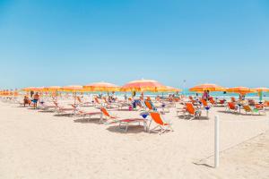 a bunch of chairs and umbrellas on a beach at JuliaMare Village in Giulianova +68 photos