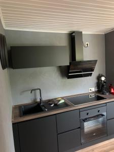 a kitchen with a sink and a counter top at Ferienwohnung Lara in Ludwigswinkel