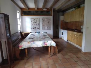 a kitchen with a table in the middle of a room at LE PETIT FROUAS CENTRE in Vielle-Saint-Girons