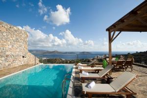 a villa with a swimming pool with a view of the ocean at Elounda Solfez Villas in Elounda