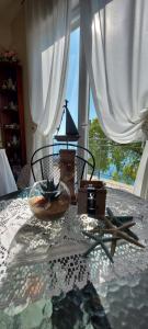 a room with a table with a lamp and a window at Villa Mira Bed and Breakfast in Duino