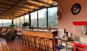 a bar in a restaurant with a view of the mountains at Buena Vista Boquete in Boquete