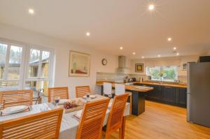 a kitchen and living room with a table and chairs at Blackmount House in Oban