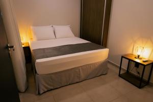 Кровать или кровати в номере TuCasa Flats - Viva uma experiência de morador!