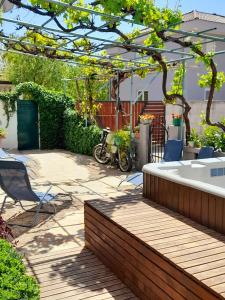 a garden with a hot tub and a pergola at Holiday Home Kotulin in Pakoštane