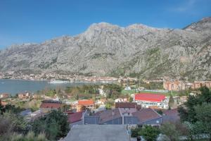 a view of a town with a mountain in the background at Apartment Peace in Kotor