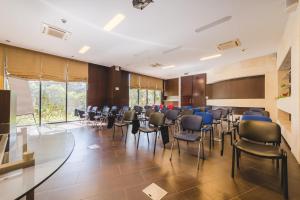 a conference room with chairs and tables and a podium at Hotel & Apartments HEC Residence in Sveti Stefan