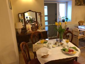 a table with a plate of food and a mirror at Willa Halina in Sandomierz