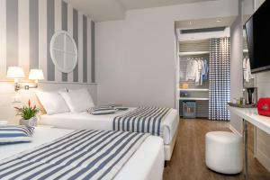 a hotel room with two beds and a kitchen at Hotel Panorama in Cattolica +40 photos