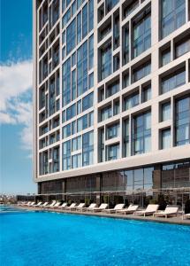 a building with a swimming pool in front of a building at Radisson Blu Hotel Istanbul Asia in Istanbul