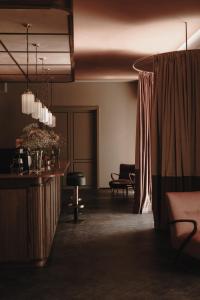 a living room with a couch and a table at Parkhotel Mondschein, a Member of Design Hotels in Bolzano