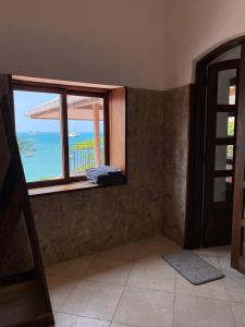 a room with a window with a view of the ocean at David Livingstone's Home in Zanzibar City