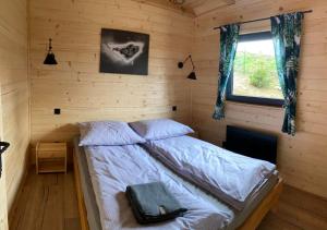 a bedroom with a bed in a wooden room at Holickie Berdo in Polańczyk +42 photos