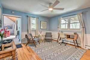 a living room with blue walls and a ceiling fan at Decked-Out Home Hot Tub, Pool, Fire Pit and More! in Monroe