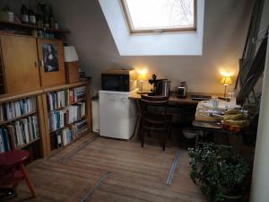 een keuken met een tafel en een witte koelkast bij Artistic loft apartment with big sun terrace in Gent