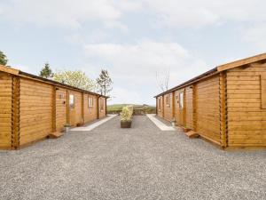 a row of wooden cabins in a row at Howgills Retreat in Kendal