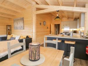 a kitchen and living room in a log cabin at Howgills Retreat in Kendal