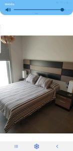 a bedroom with a large bed with a wooden headboard at Las Terrazas II in Granadilla de Abona +69 photos