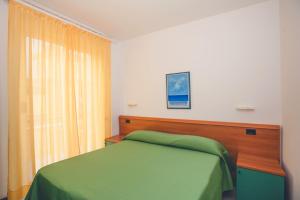 A bed or beds in a room at Residence Il Monello