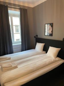 a hotel room with two beds and a window at Birka Hotel in Stockholm